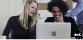Image of two adult women looking at a laptop