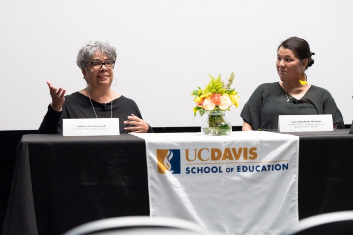 Barbara Brandon-Croft and Tara Nakashima Donahue sit at a table with a School of Education logo.