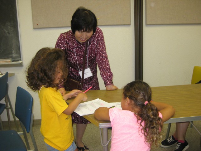 A Korean teacher interacts with summer enrichment camp participants.