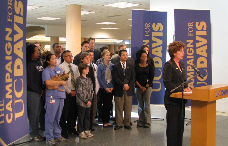 Community representatives standing with Chancellor Linda Katehi as she addresses a crowd