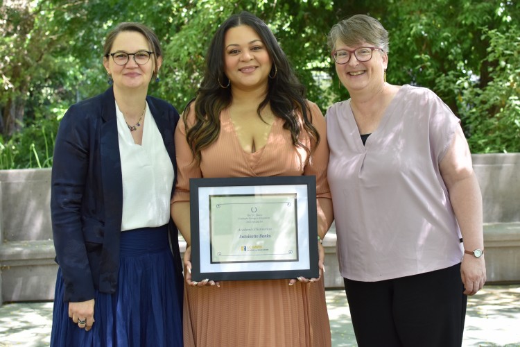 Dr. Cynthia Carter Ching and Dr. Lauren Lindstrom pose with mentee Antoinette Banks, who is holding an award certificate