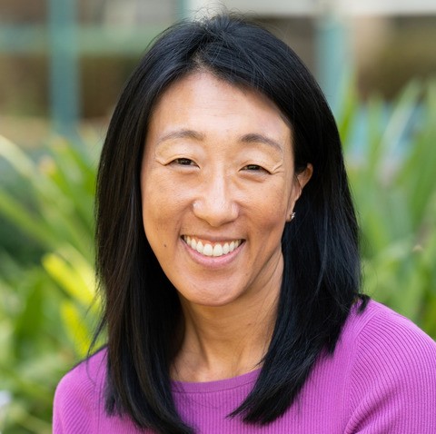 Dr. Nancy Tseng poses in a purple shirt for a headshot.