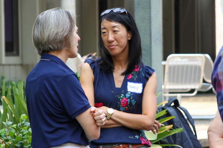 Rebecca Ambrose speaks with Nancy Tseng at an outdoor event