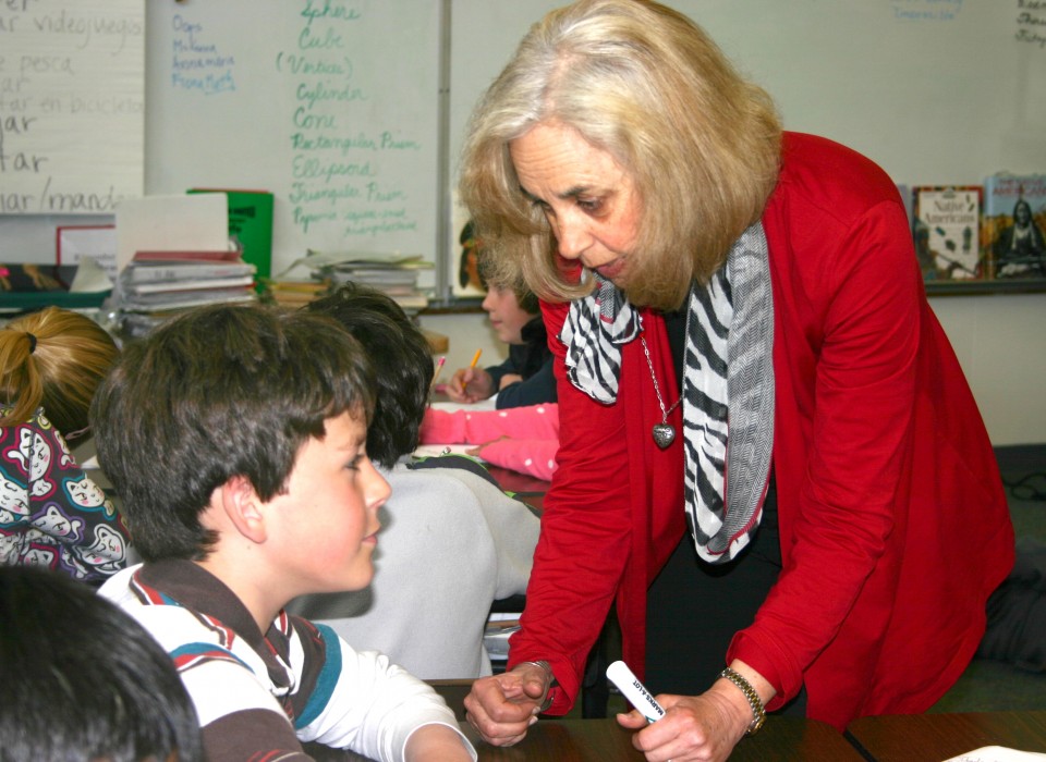 Teacher Sue Davis helping a student in her classroom