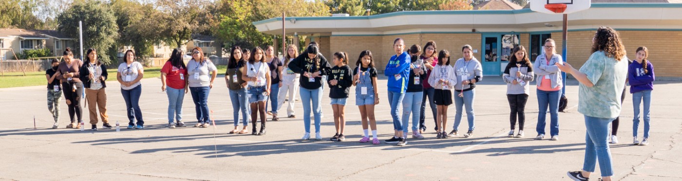 Line of students on school playground prepares to launch rockets