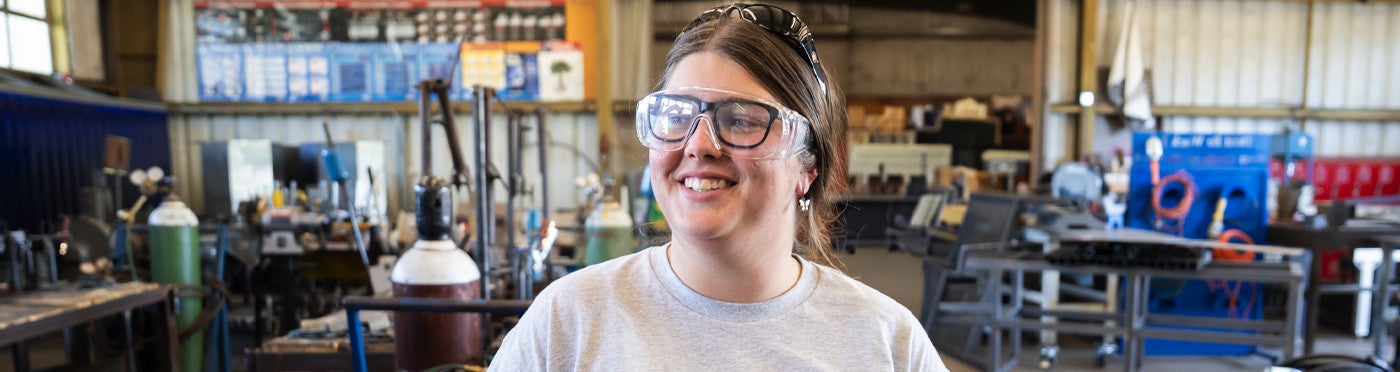 Ag Ed teacher standing in high school machine shop to teach welding