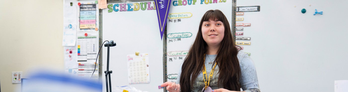 Credential student teaching at board in elementary class