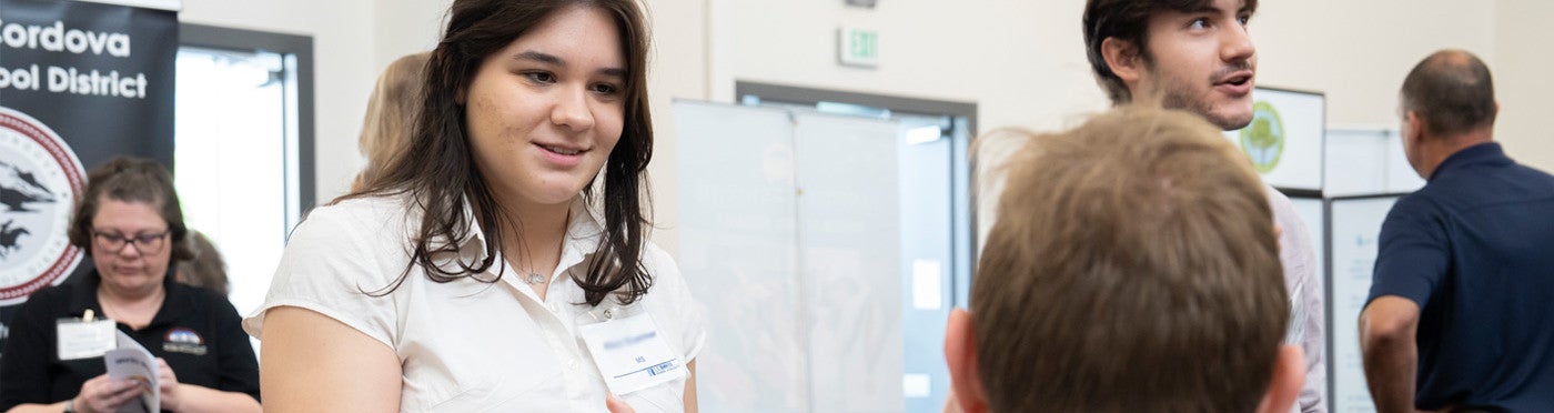Credential student speaks with district recruiter at UC Davis teacher job fair