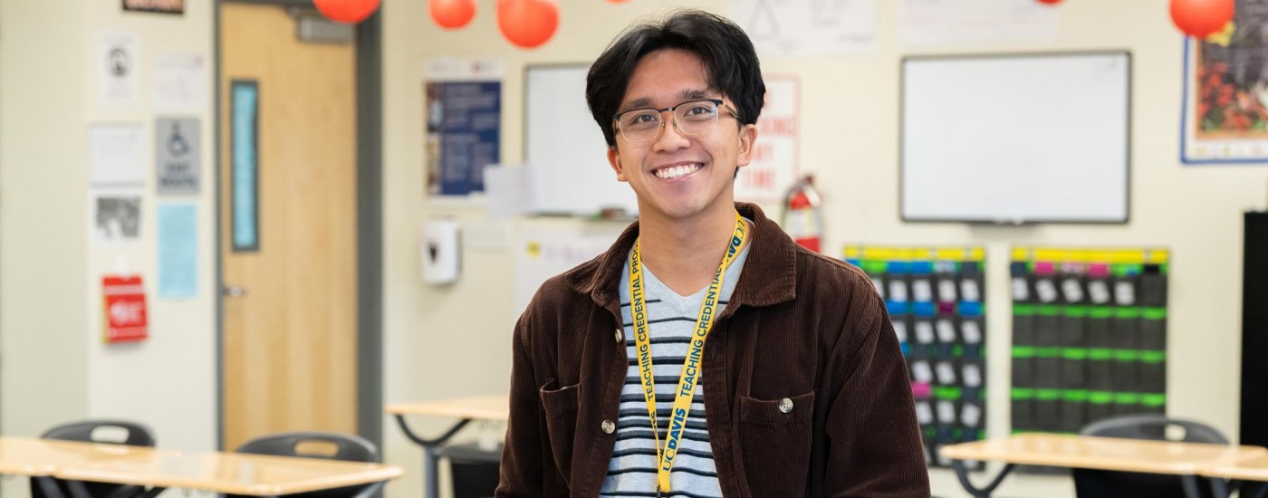 Student teacher standing in classroom wearing School of Education lanyard