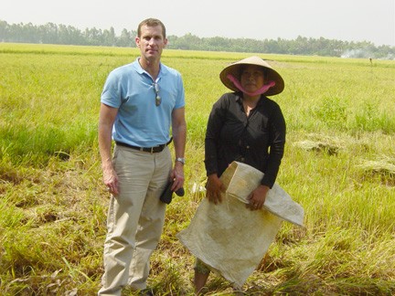 Portrait of Cary Trexler with a farmer in Southeast Asia