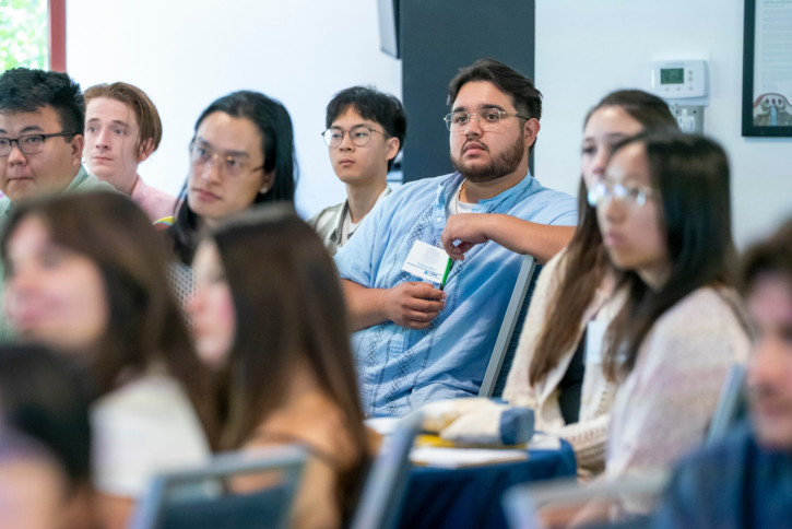 Students look toward the front of the room, listening.