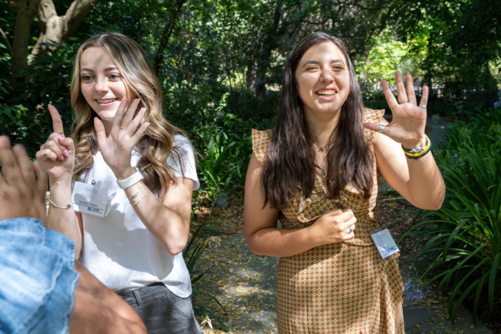 Students hold up their fingers, trying to silently arrange themselves in a line by birth date.