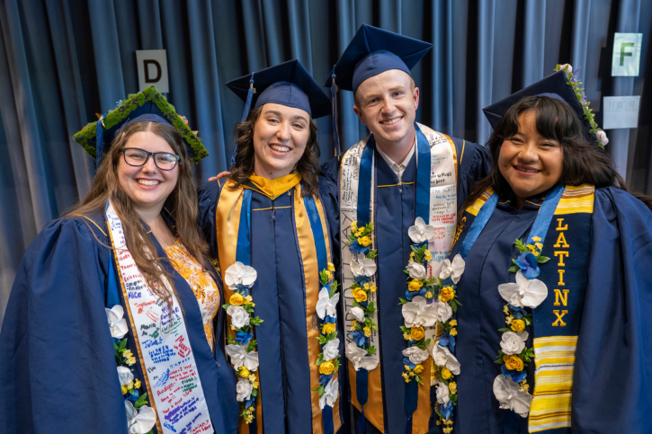 The agriculture credential graduates smile, all wearing floral stoles made by their students.