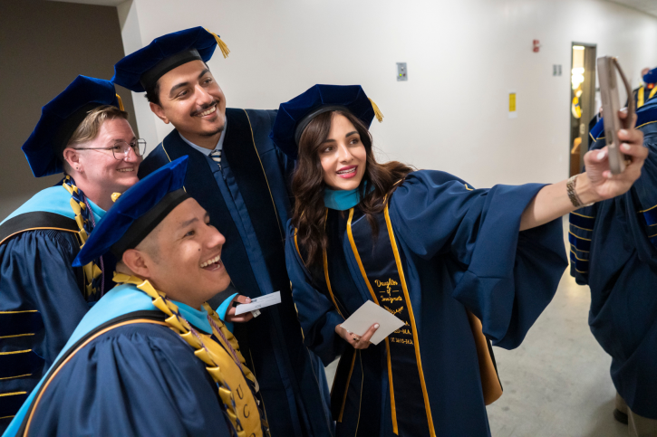 Ed.D. grads take a selfie backstage.