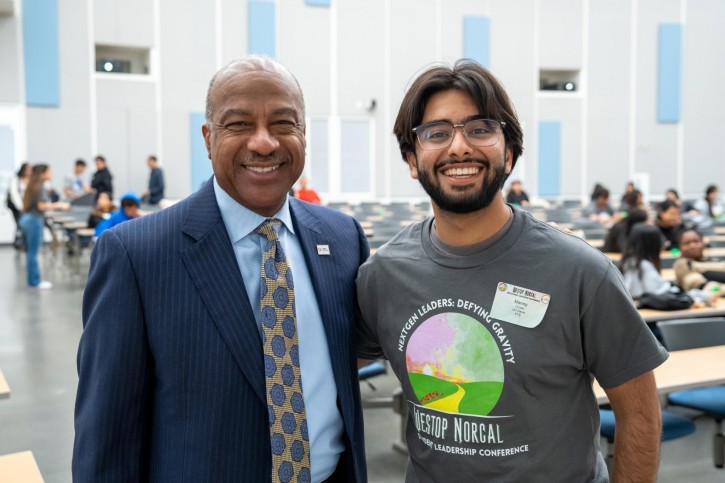 Chancellor Gary May poses with a student.