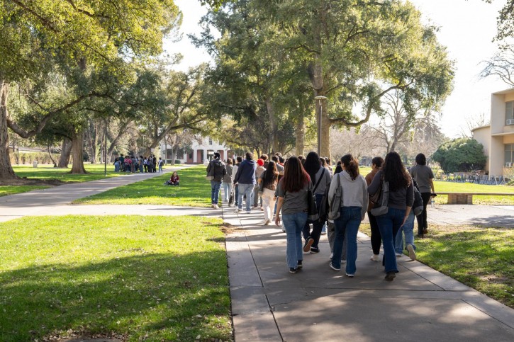 A group of students tour the UC Davis campus.