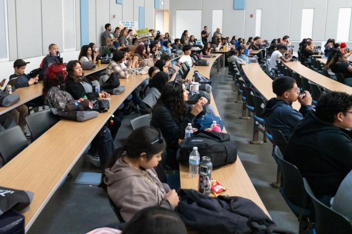 Students fill seats in a lecture hall.