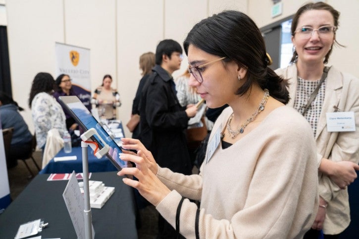 A student types information into an iPad.