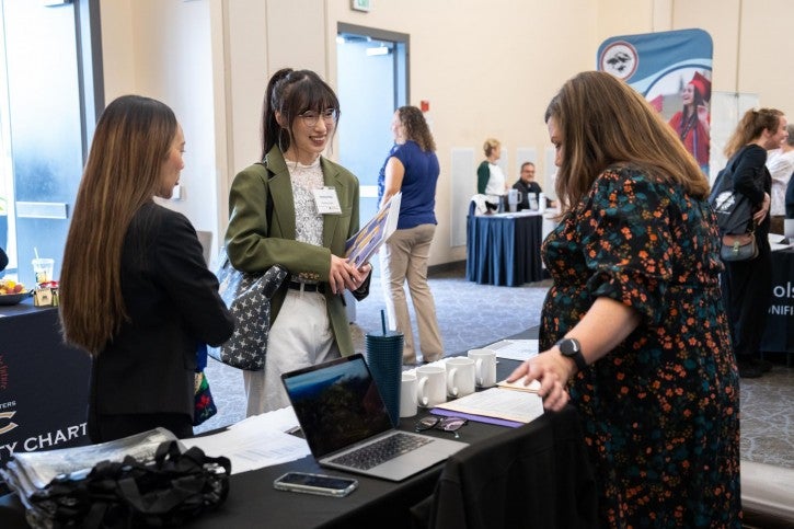 Two students talk to a district rep.