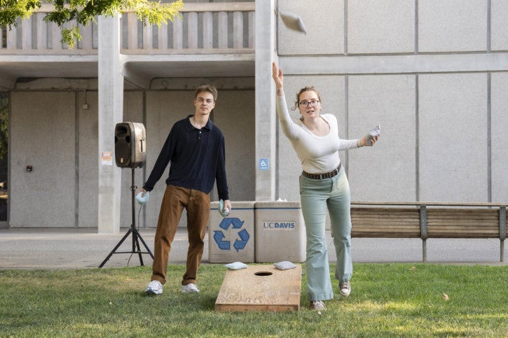 Faculty, staff, and students compete in a corn hole tournament.