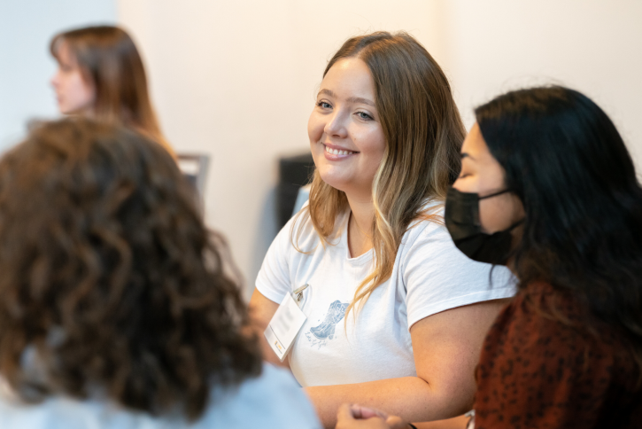 Students smile while listening to the speaker