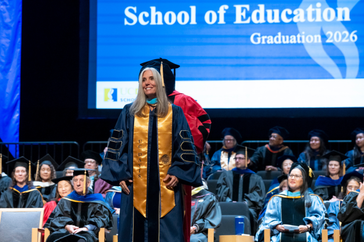 An EdD grad smiles from the stage.