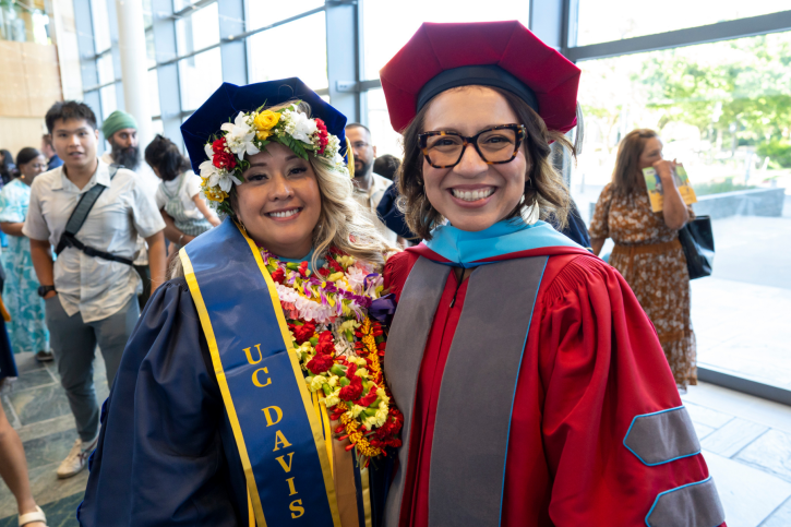 EdD grad Kat smiles next to her advisor, Dr. Montaño.