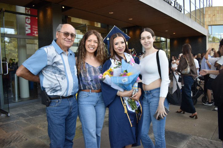 Credential grad Luz smiles with her family.