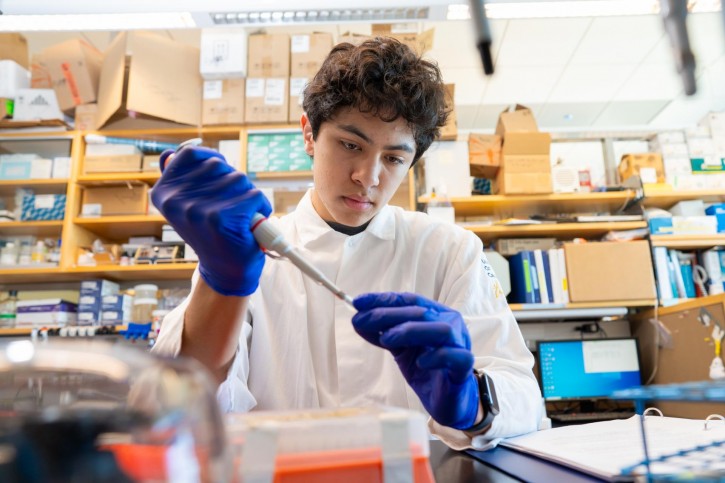 Andrew uses a syringe to fill a small tube