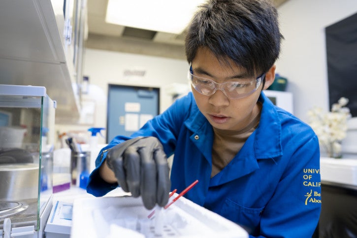 Caden carefully works on an experiment in the lab.