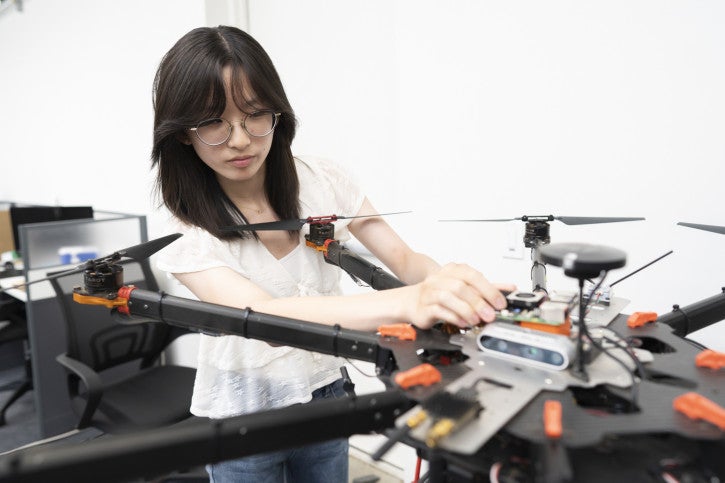 Callie works on a drone in the lab.