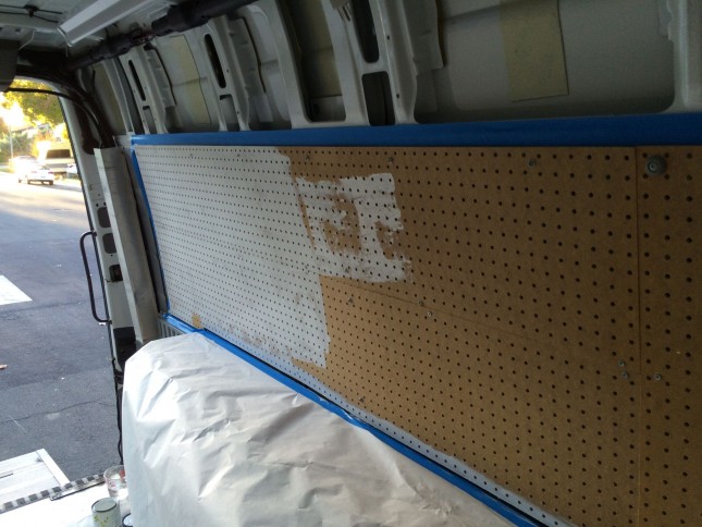 Priming the pegboard before painting. 