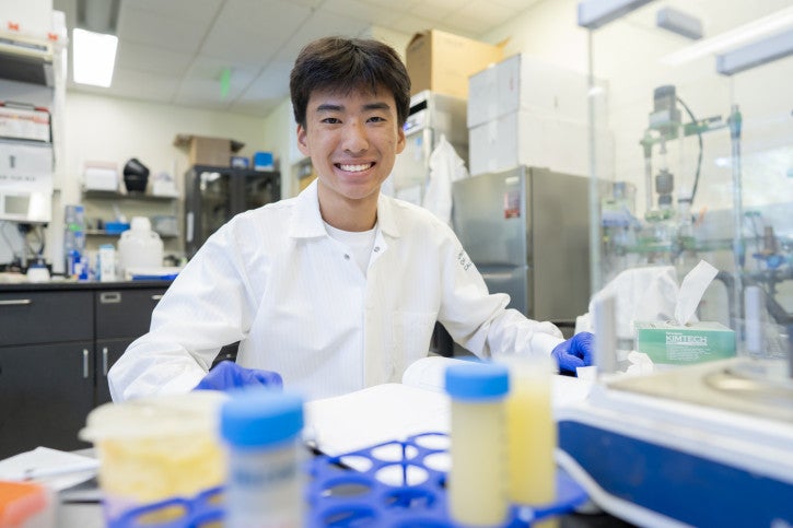 Jonathan smiles for the camera. Small vials are visible in the foreground.