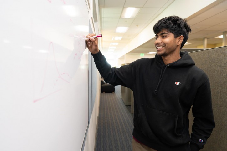 Merdy writes on a whiteboard