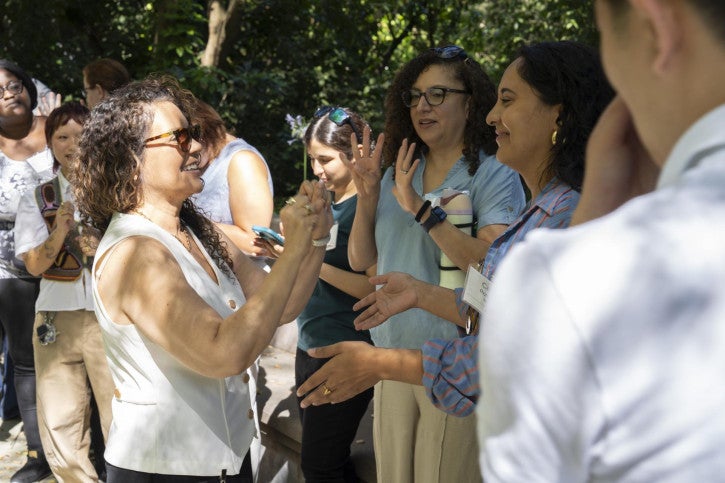 Lecturer and supervisor Rebecca Rosa plays Rock, Paper, Scissors with a credential student.
