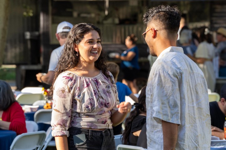 Two people smile and talk