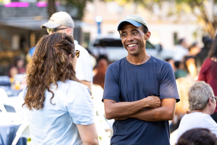 Two people smile and talk