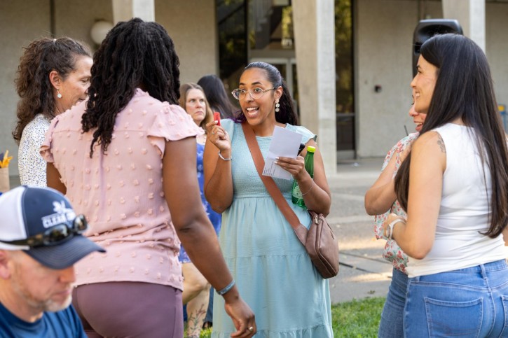 A group of women smile and laugh