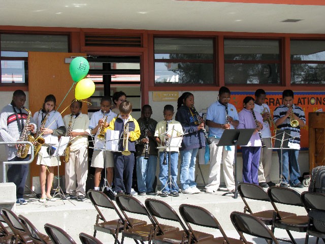 Youth band members performing for an audience