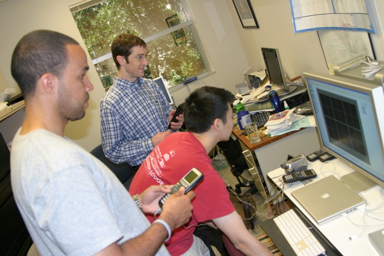 Tobin White, assistant professor of mathematics education, working with two graduate students