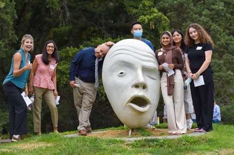 A group of teaching credential students poses with an egghead on the UC Davis campus