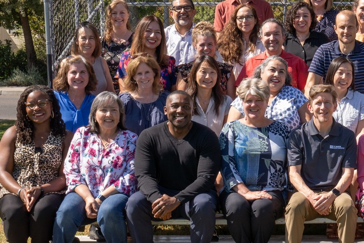 Charles Wilkes sits among colleagues posing for a group photo