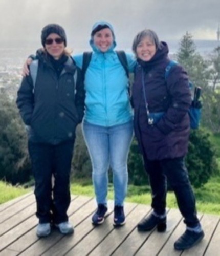 Robin Martin, Rachel Restani, and Margarita Jimenez-Silva stand together at a mountain  lookout point