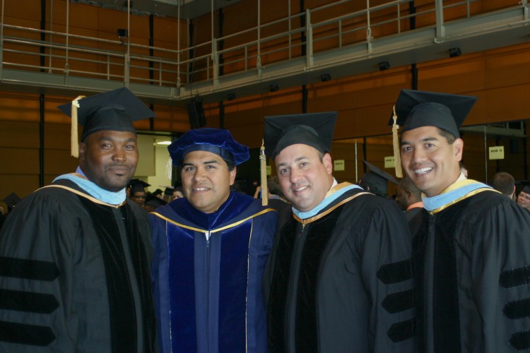 Group of UC Davis School of Education graduates in caps and gowns