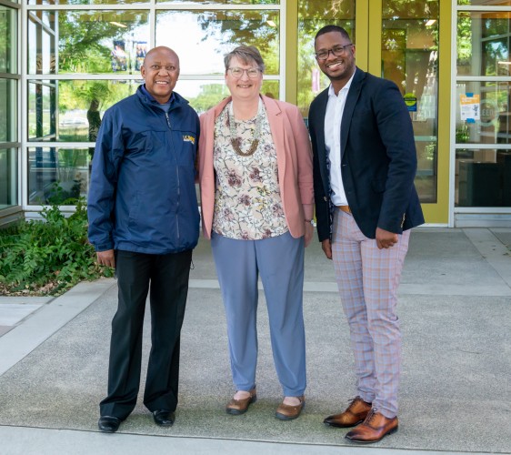 Maximus Sefotho, Lauren Lindstrom and Anthony Brown stand in front of a UC Davis building