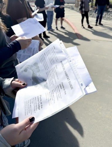 Close up of a Spinning Salmon handout that a student is holding.