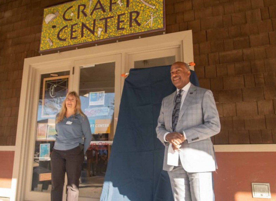 Chancellor May stands with staff person in front of Craft Center building