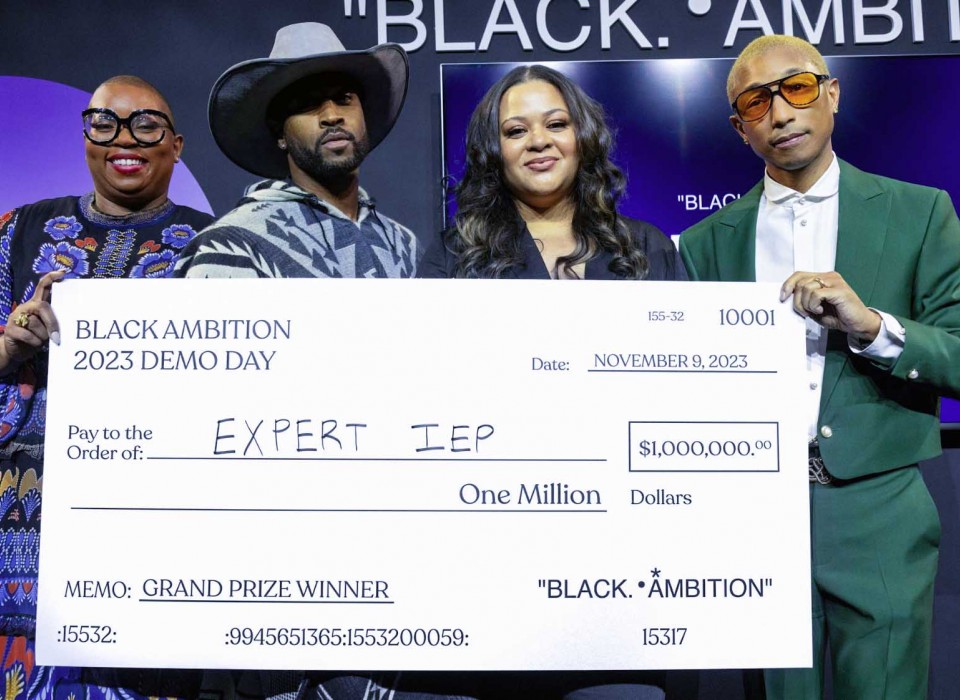 Black Ambition CEO Felecia Hatcher, Leonard Creer, Antoinette Banks and Pharrell Williams pose at the Black Ambition event holding a giant facsimile check for $1 million