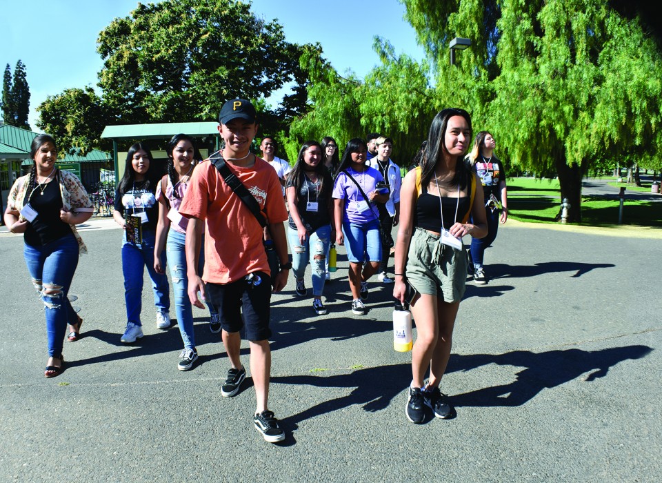 A group of students walking on a college campus