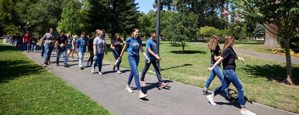 A group of Upward Bound students walk across campus